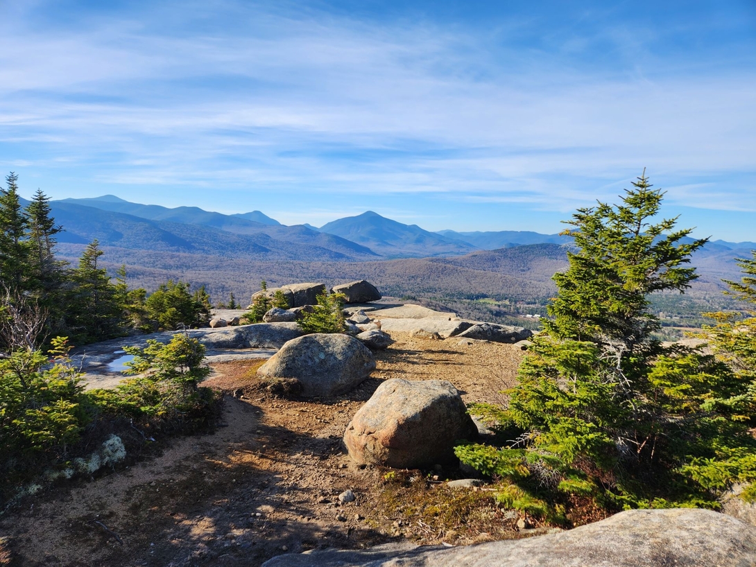 The massive Balanced Rocks overlook a broad panorama of the Adirondack High Peaks.