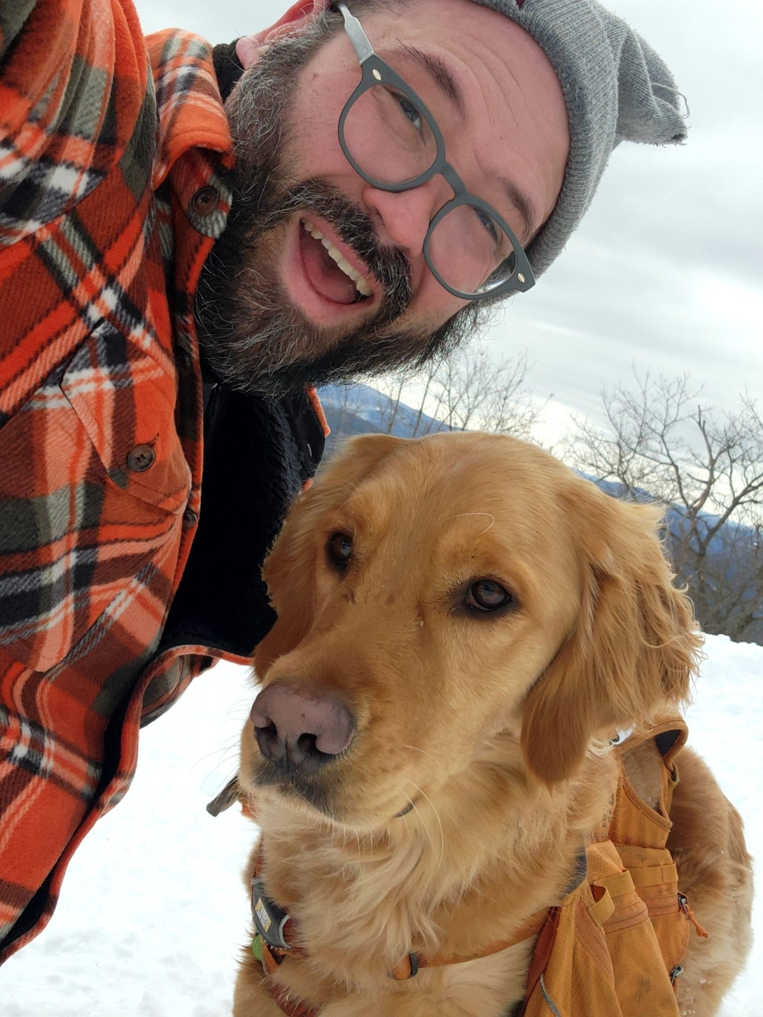Adam and Sunny take a summit selfie on snowy Cat Mountain.