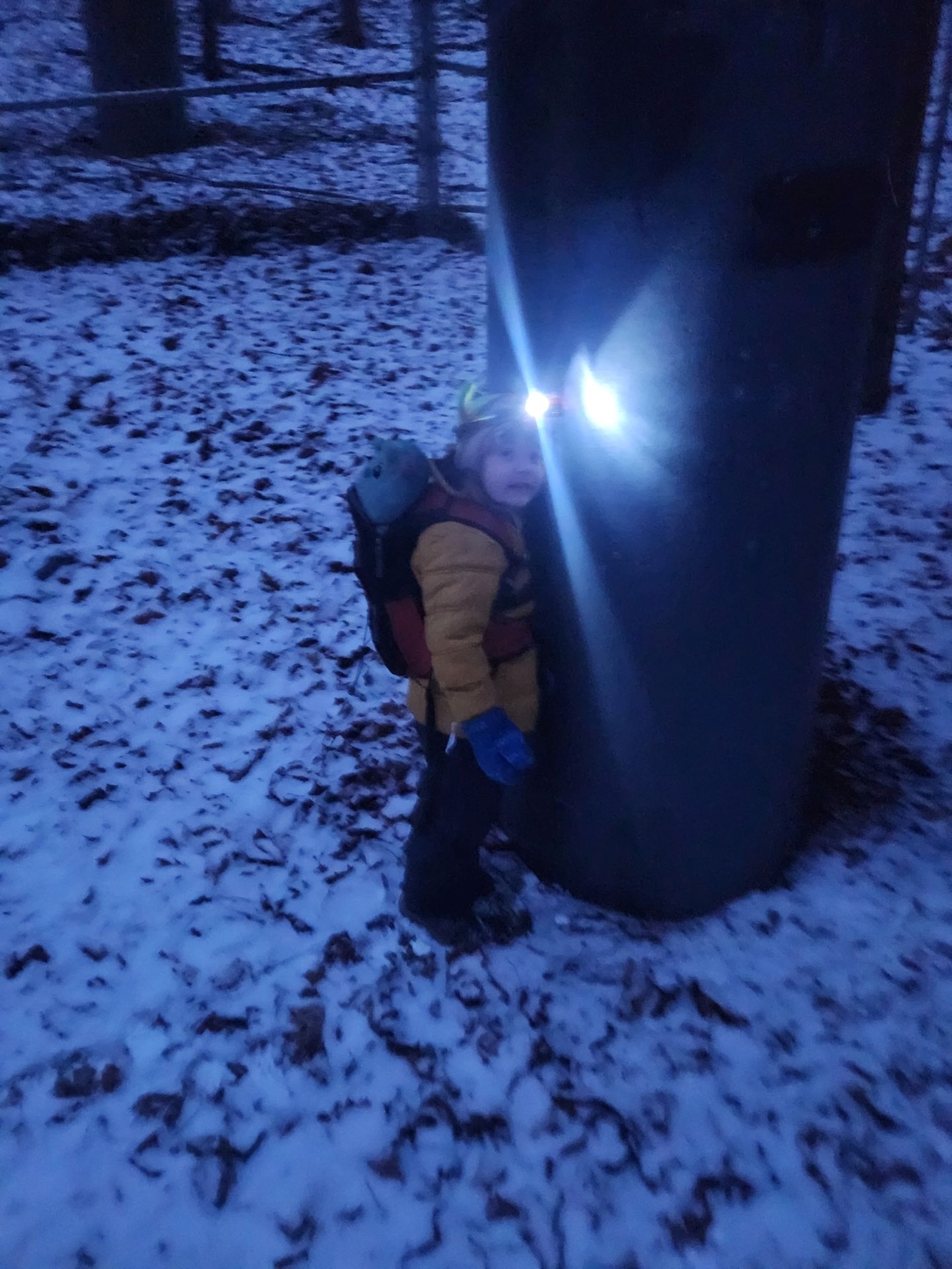 quinn in the dark in the snow with headlamp